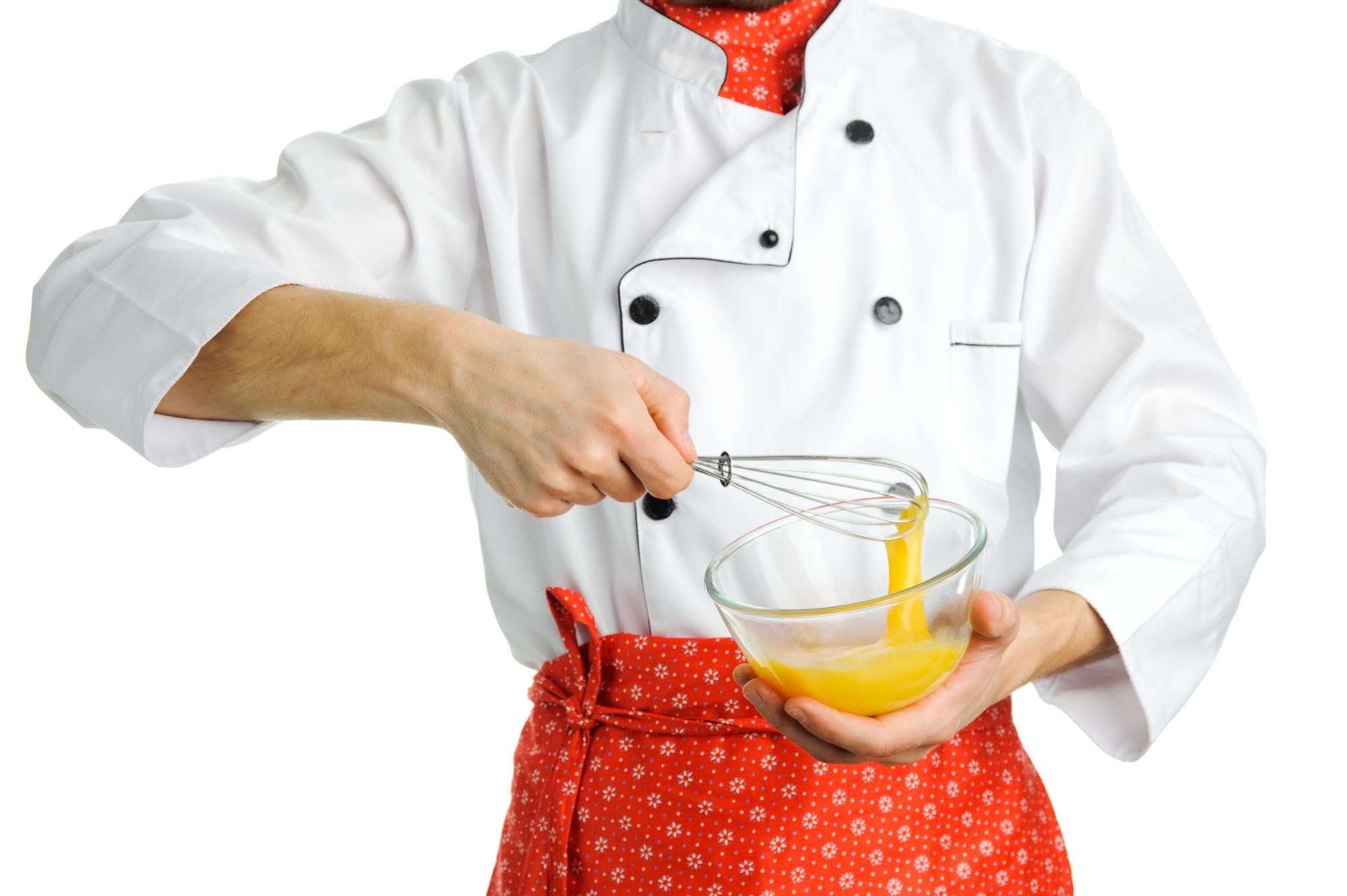 Instructor stirring a pot in a bright kitchen